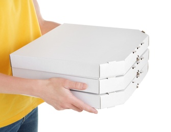 Woman holding cardboard pizza boxes on white background