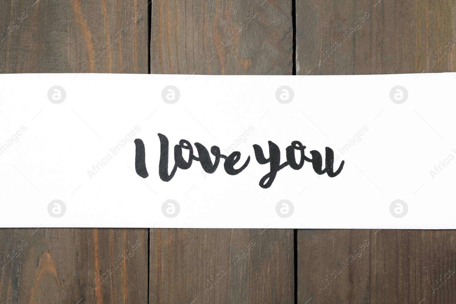 Photo of Card with text I Love You on wooden background, top view