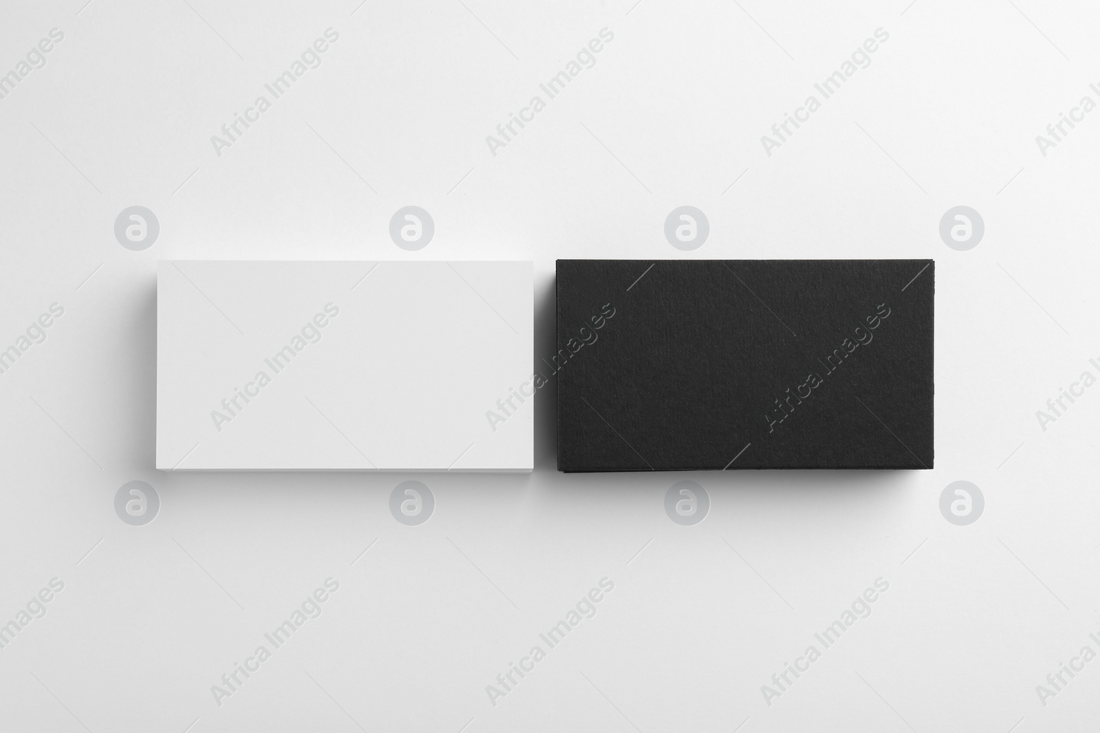 Photo of Blank business cards on white background, flat lay. Mockup for design