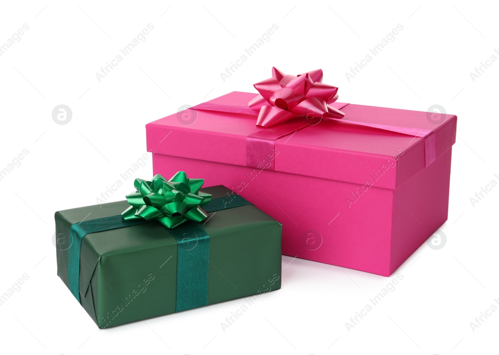 Photo of Pink and green gift boxes with bows on white background