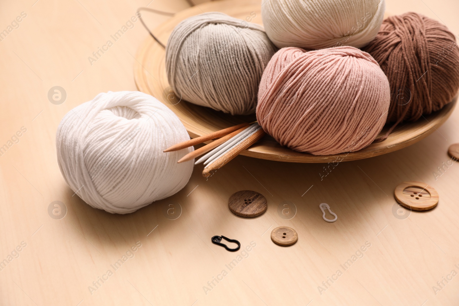 Photo of Composition with threads and crafting accessories on wooden table. Engaging hobby
