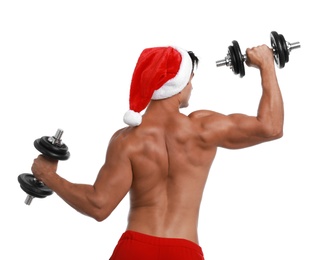 Sexy shirtless Santa Claus with dumbbells on white background
