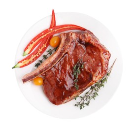 Photo of Raw marinated meat with thyme, chili pepper and tomatoes isolated on white