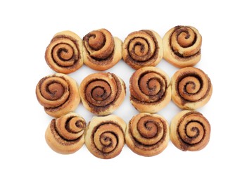 Photo of Many tasty cinnamon rolls isolated on white, top view