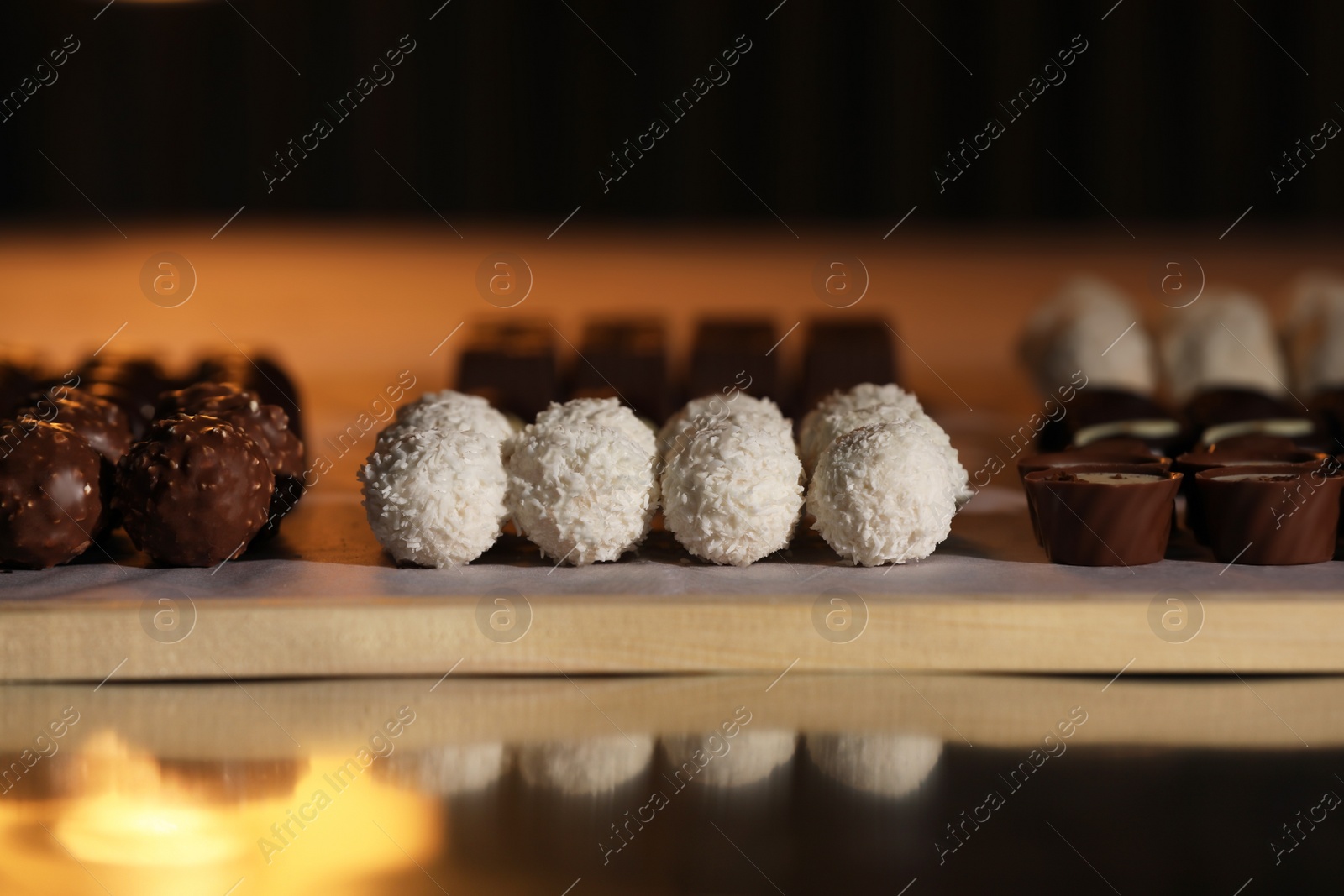 Photo of Many delicious chocolate candies on table, closeup. Production line