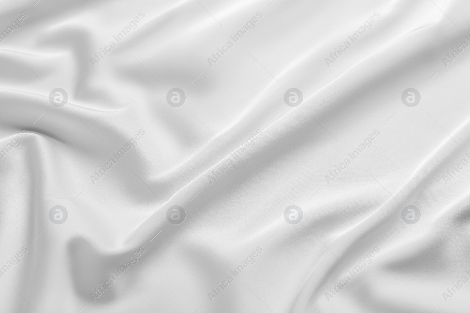 Photo of Texture of white silk ripple fabric as background, top view