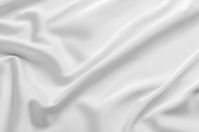 Photo of Texture of white silk ripple fabric as background, top view