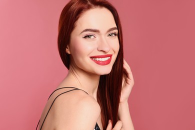 Photo of Happy woman with red dyed hair on pink background