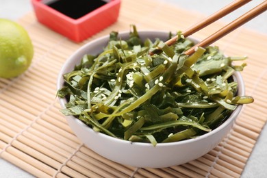 Photo of Fresh laminaria (kelp) seaweed served on table, closeup