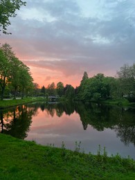 Photo of Picturesque view of pond at bright sunset