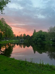 Picturesque view of pond at bright sunset