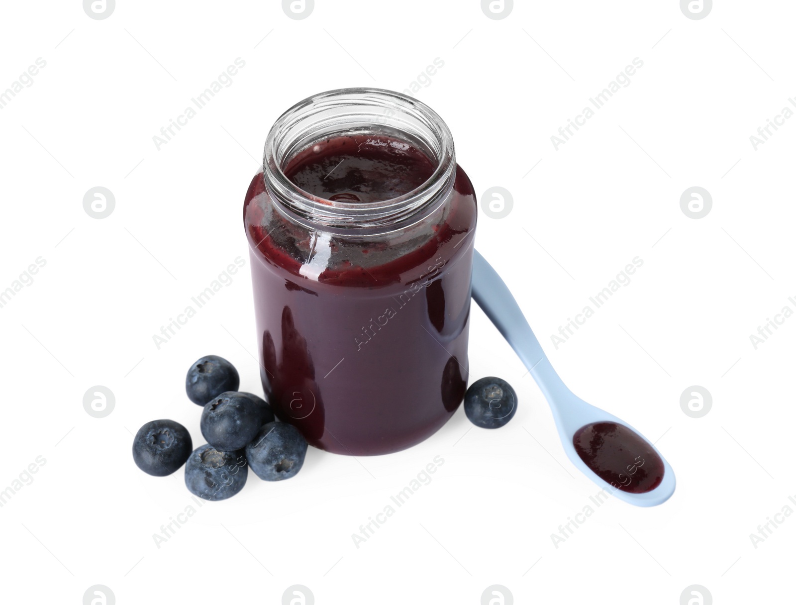 Photo of Jar of healthy baby food, fresh blueberries and spoon isolated on white