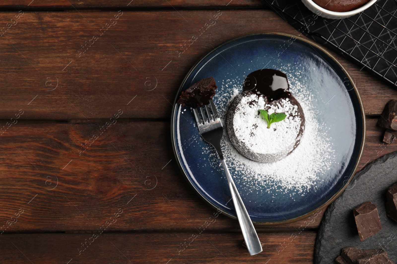Photo of Delicious fresh fondant with hot chocolate and mint on wooden table, flat lay. Space for text