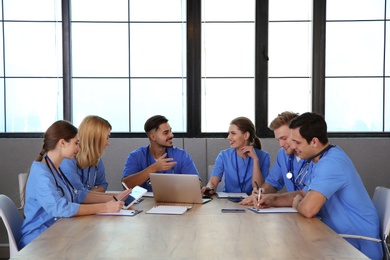 Medical students in uniforms studying at university