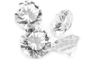 Photo of Different beautiful shiny diamonds isolated on white