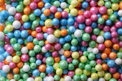 Pile of small colorful beads as background, top view