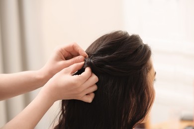 Photo of Hair styling. Professional hairdresser working with client indoors, closeup