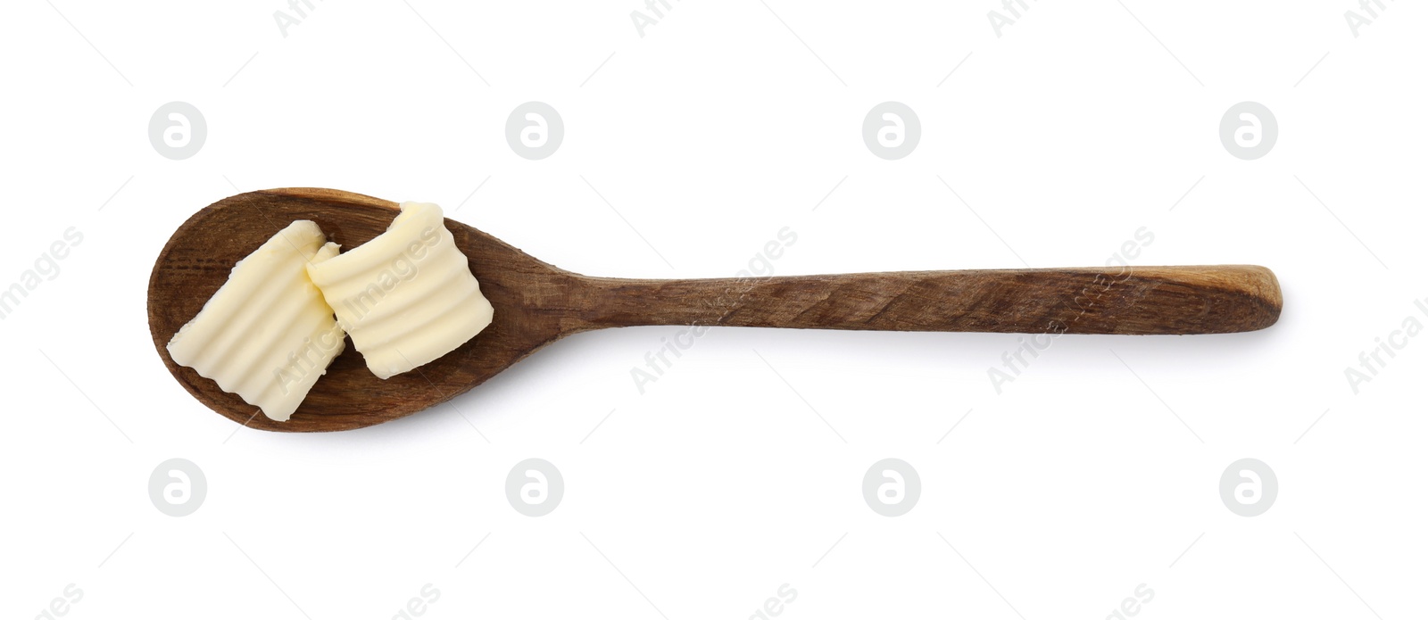 Photo of Butter curls in spoon isolated on white, top view