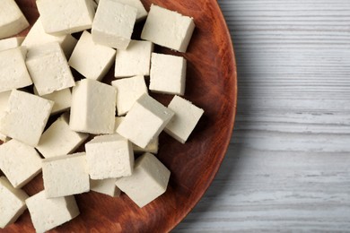 Photo of Delicious tofu on white wooden table, top view