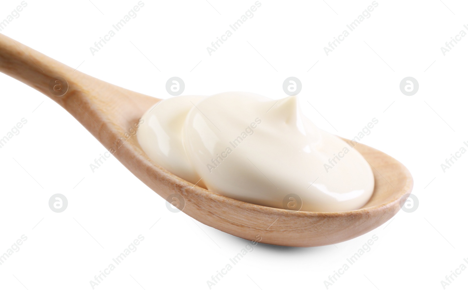 Photo of Natural yogurt in wooden spoon isolated on white