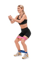 Woman exercising with elastic resistance band on white background