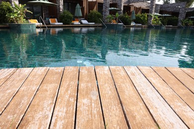 Wooden deck, swimming pool and recreational area at luxury resort