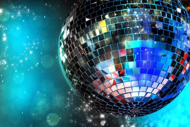 Image of Shiny disco ball on dark cyan background with blurred lights, space for text. Bokeh effect