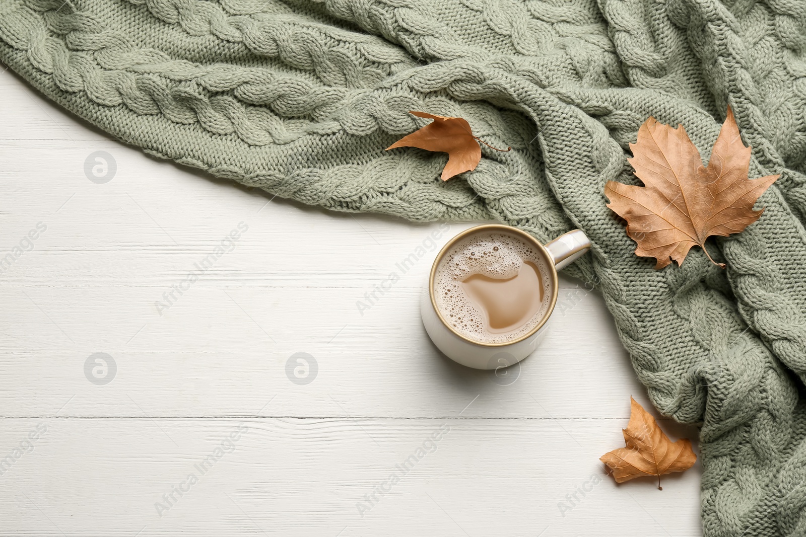 Photo of Flat lay composition with coffee and warm plaid on white wooden table, space for text