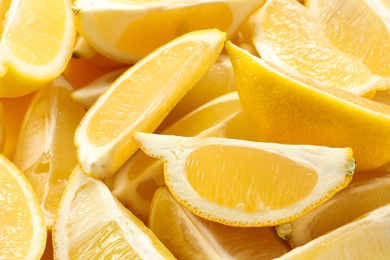 Photo of Many fresh juicy lemon slices as background, closeup