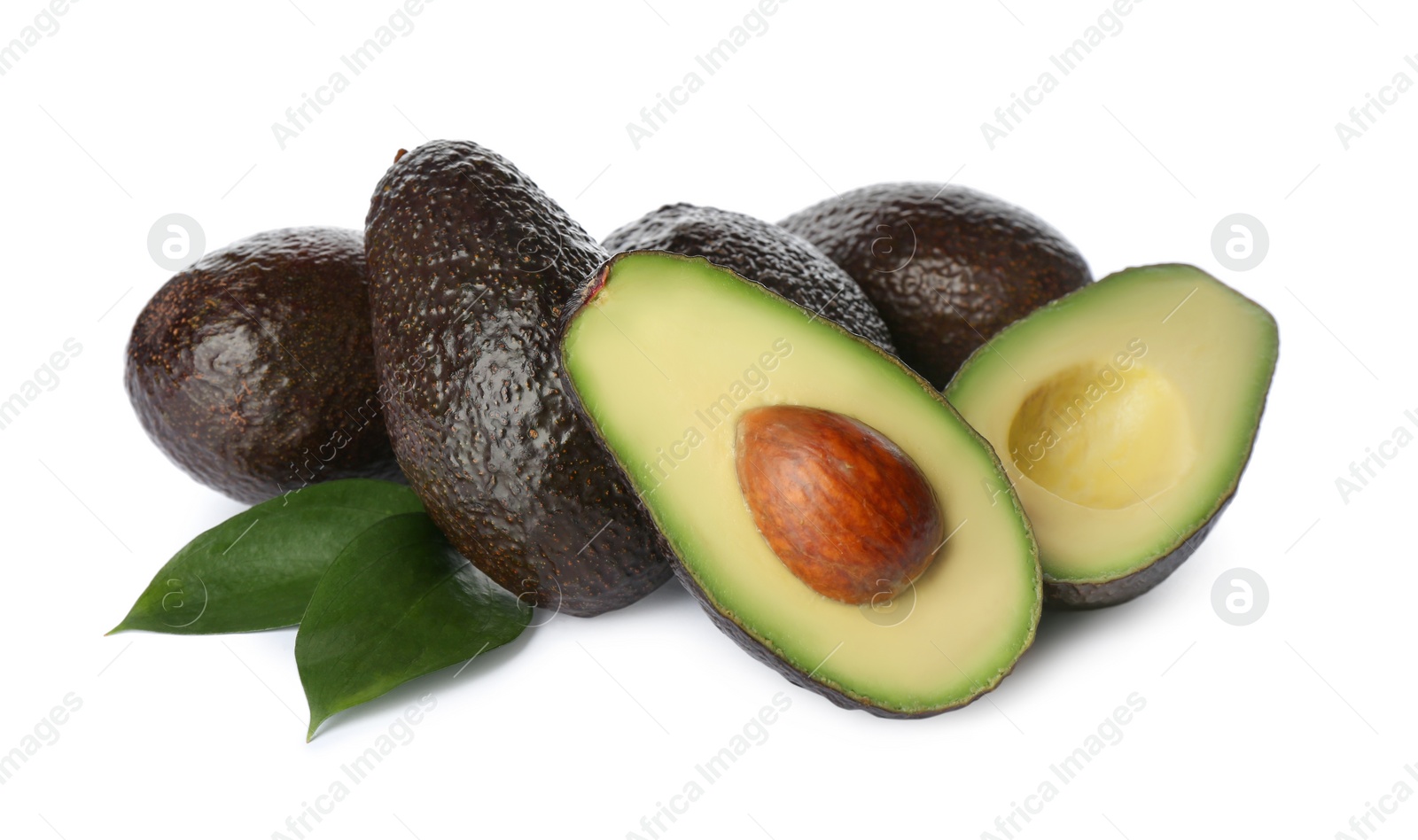 Photo of Cut and whole hass avocadoes with green leaves on white background