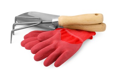 Photo of Gardening gloves, trowel and rake isolated on white