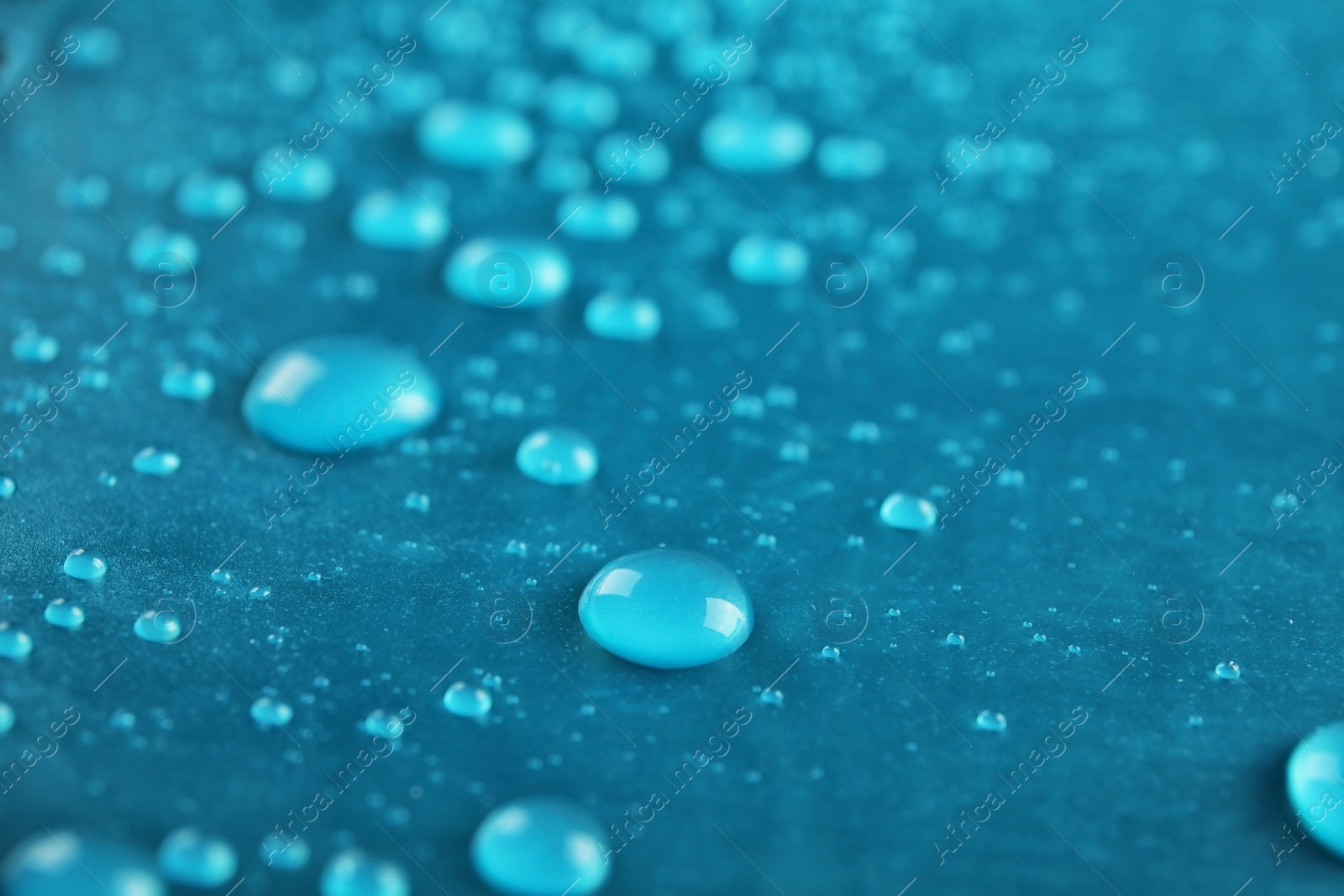 Photo of Many clean water drops on color background