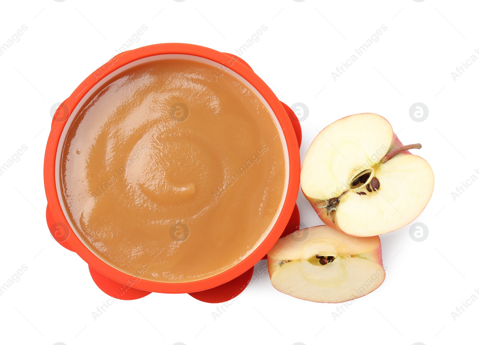 Photo of Tasty baby food in bowl and cut apple isolated on white, top view