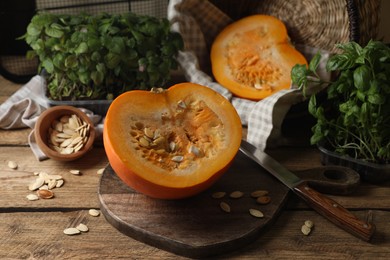 Photo of Cut fresh ripe pumpkin on wooden table