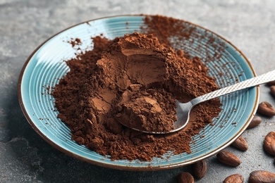 Photo of Plate with cocoa powder on table