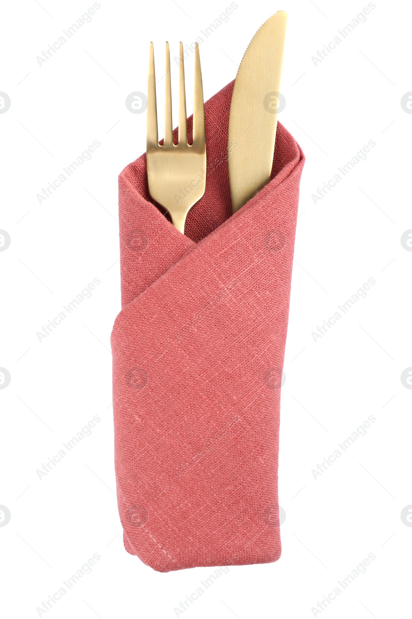 Photo of Golden fork and knife wrapped in coral napkin on white background, top view