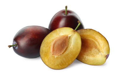 Photo of Whole and cut ripe plums on white background