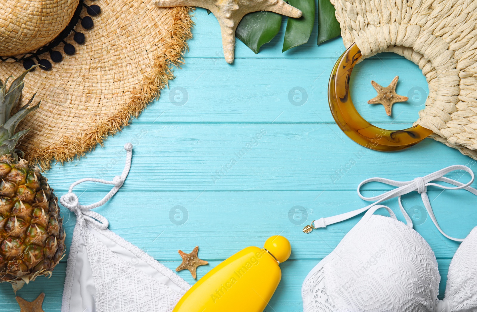 Photo of Flat lay composition with beach objects on light blue wooden background. Space for text