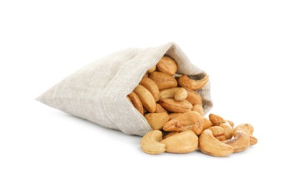 Photo of Sack and tasty organic cashew nuts isolated on white