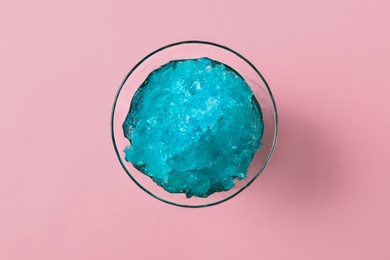 Photo of Shaving ice in glass dessert bowl on pink background, top view