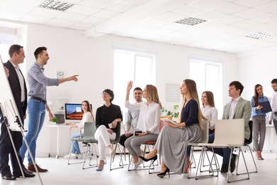 Photo of Business trainers giving lecture in office