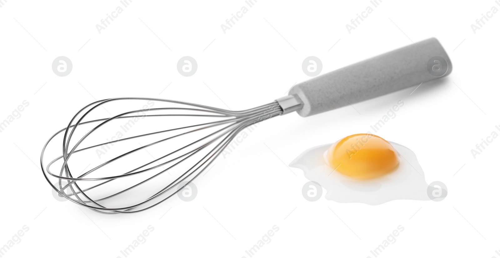 Photo of Whisk and raw egg isolated on white