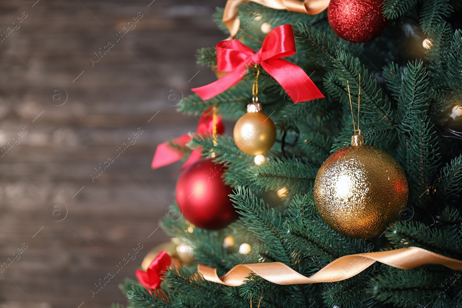 Photo of Beautiful Christmas tree with festive decor on dark background. Space for text