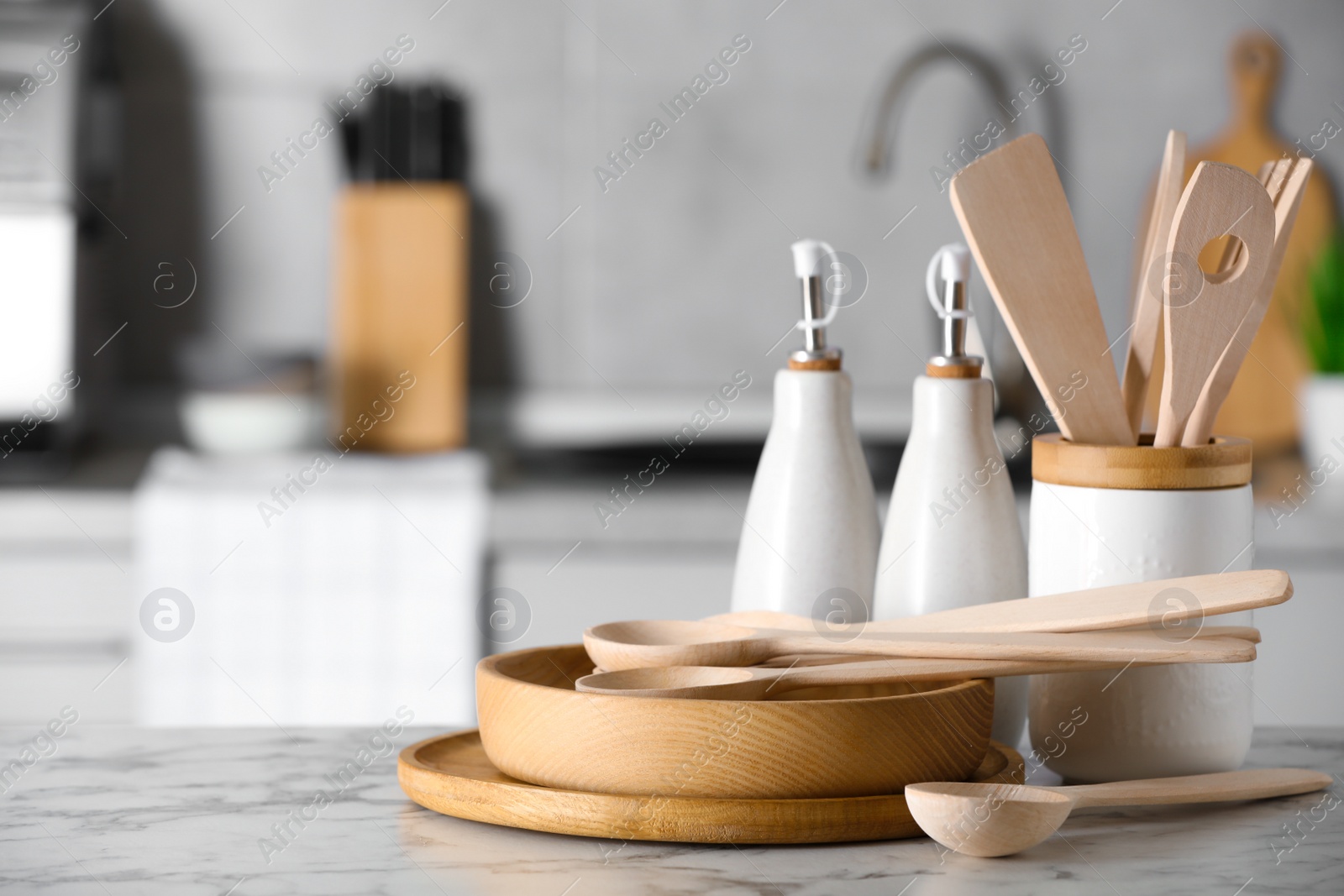 Photo of Cooking utensils and dishes on white marble table in kitchen. Space for text