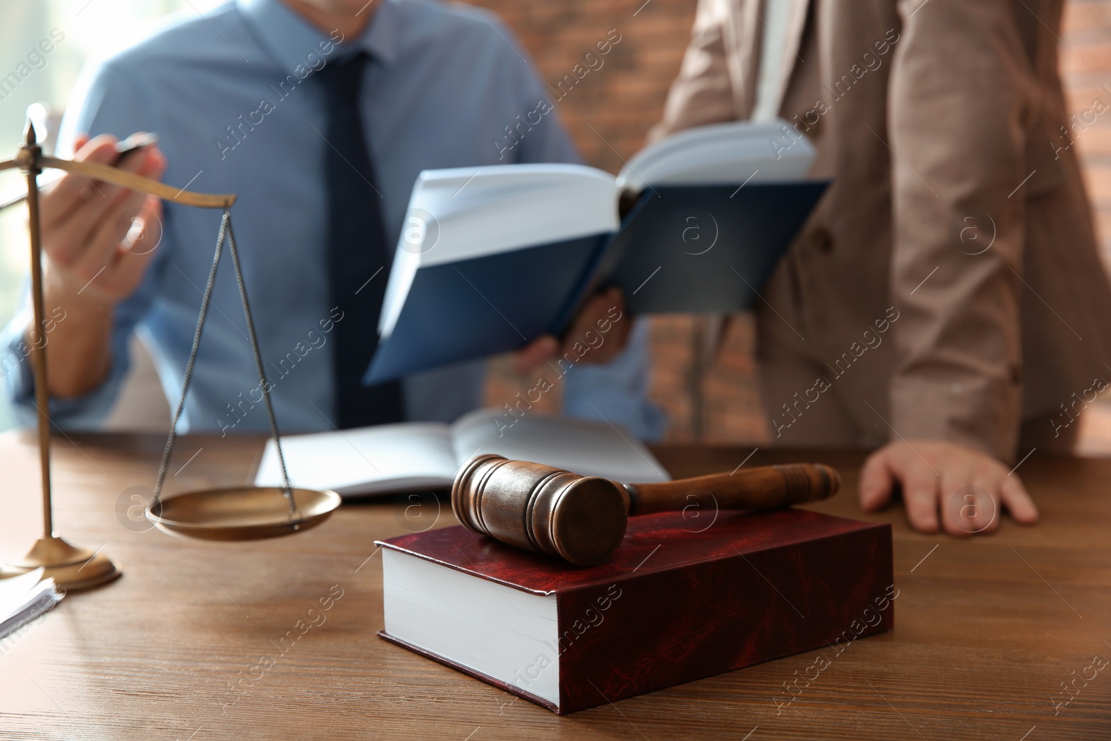 Photo of Notaries working at table in office, focus on judge gavel and book. Law and justice concept