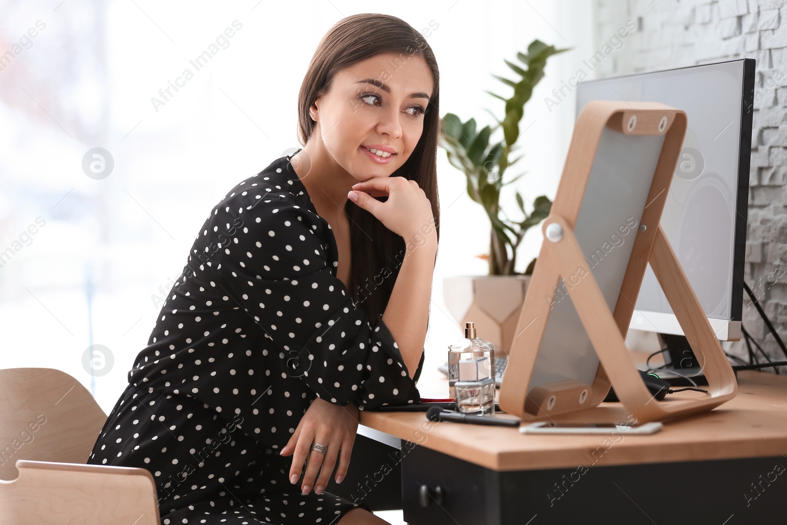 Photo of Young beautiful woman looking in mirror at home