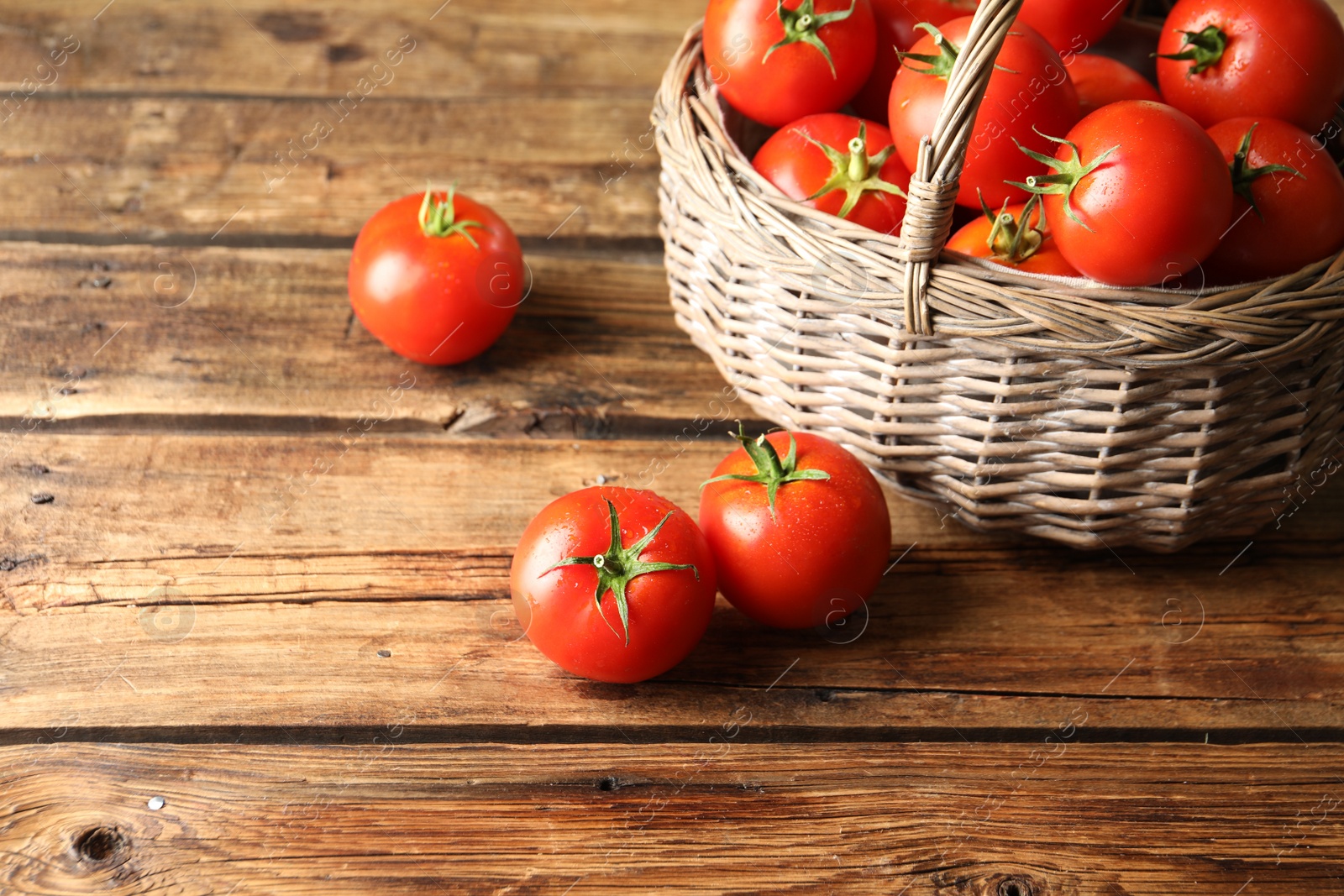 Photo of Fresh ripe red tomatoes on wooden table