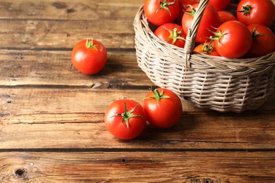 Photo of Fresh ripe red tomatoes on wooden table