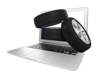 Image of Online auto store, delivery service. Modern laptop and car tires on white background