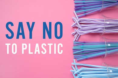 Image of Text SAY NO TO PLASTIC and disposable cups with straws on pink background, flat lay